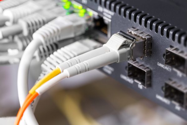close up of high speed fiber network switch and cable scaled 1