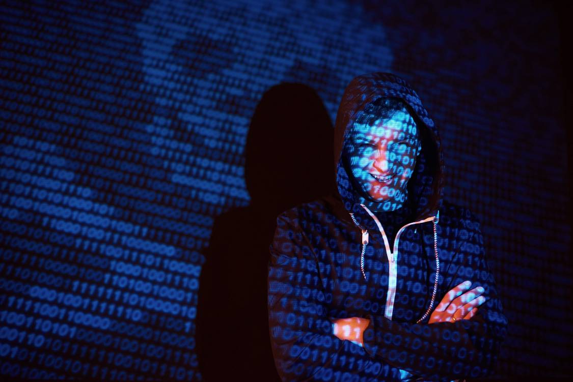 Unrecognizable hooded male hacker